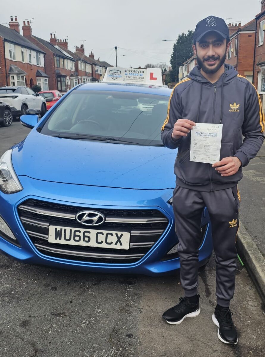 Learner standing beside a driving school car