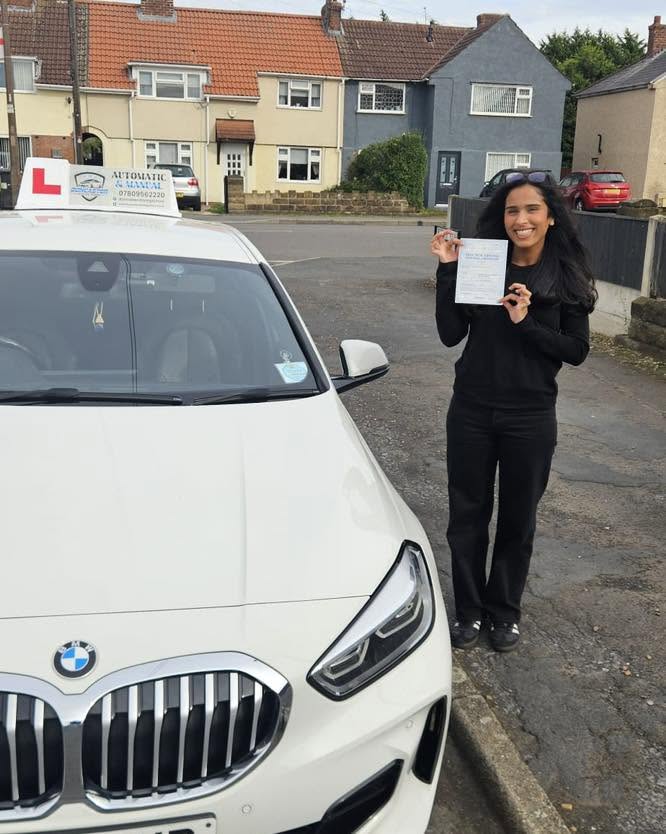 Jemimah celebrating passing her manual driving test in Doncaster with instructor Marian